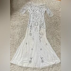 While sequined embroidered gown